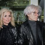 American singer, songwriter and actress Debbie Harry wore a black leather jacket and a black scarf, and American artist Andy Warhol wore a black turtle sweater in a black leather jacket for AIDS at St. Vincent Hospital in Barney, New York, Nov. 10, New York, November 10, 1986.