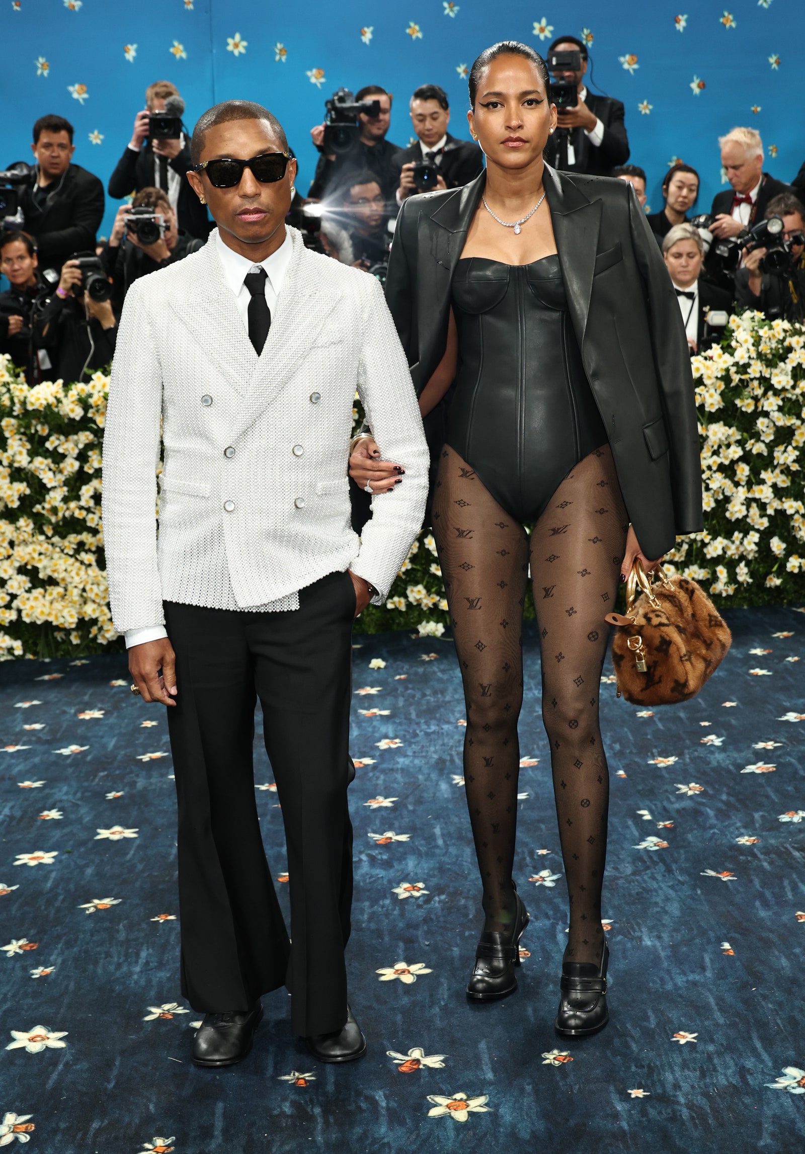 Images may contain Pharrell Williams Caraun Reid Fred Sherry Wang Ning Yang Jun Jun Adult Clothing and Footwear