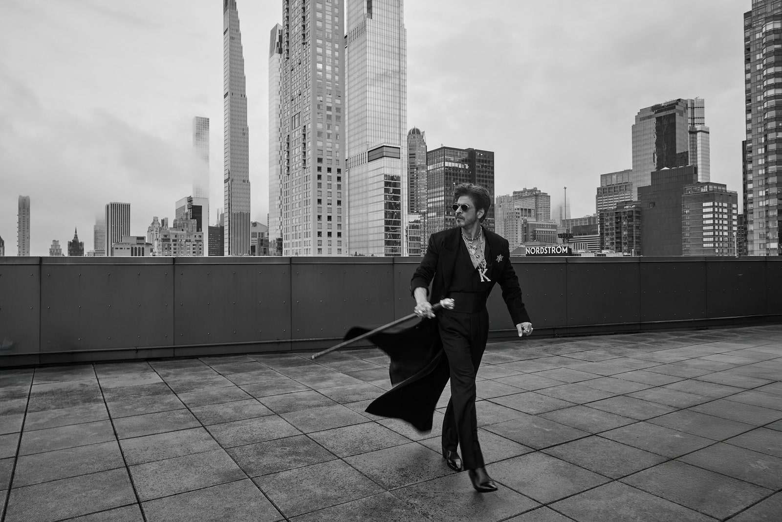 Images may contain Shahrukh Khan City Metropolis City Clothing Sword Weapons Adults and Footwear