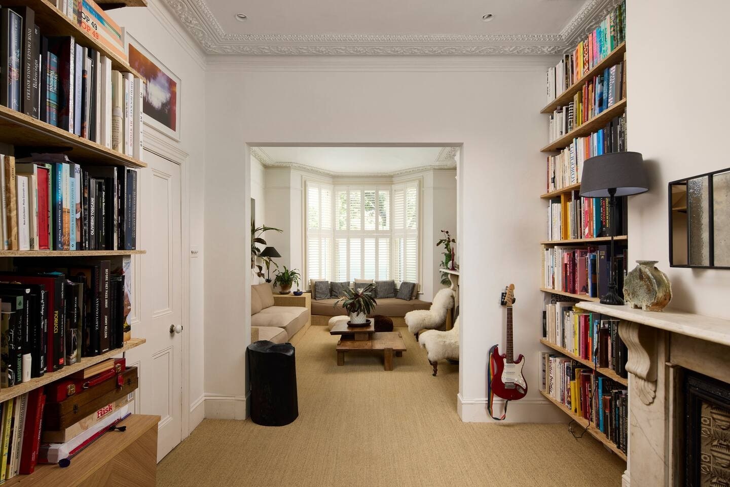 Images may contain furniture plants guitar musical instrument bookcase sofa lights animal dog dog and pet