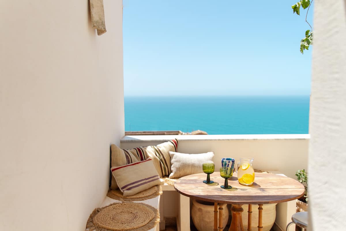 Images may contain architectural balcony building table furniture and table