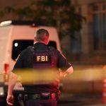 A man was wearing a bulletproof vest and turned his back.