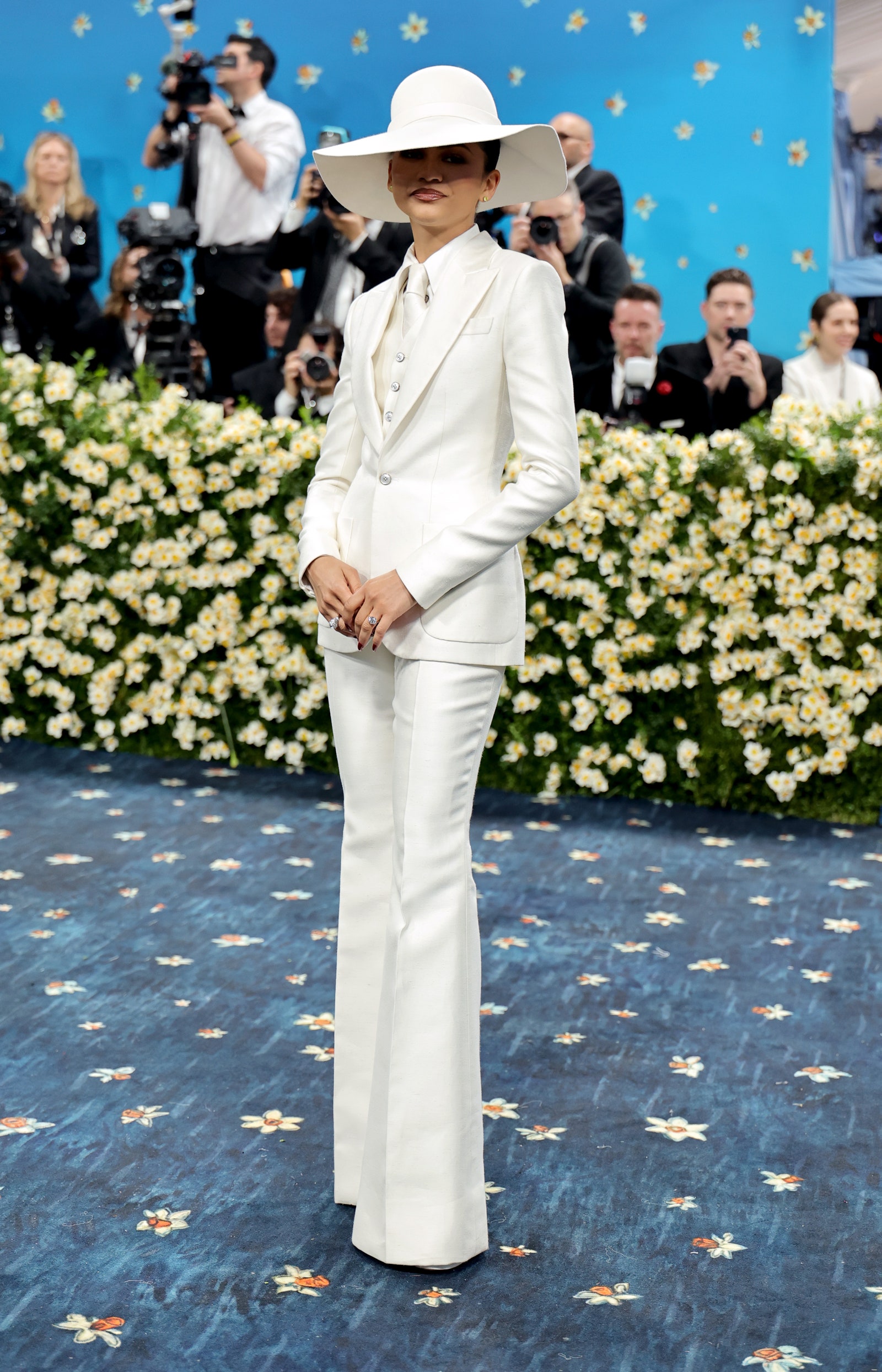 Images may contain Zendaya adult clothing hat camera electronics stand accessories jewelry and rings