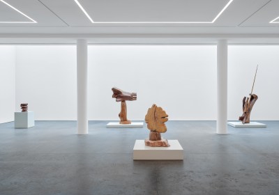 A group of wood sculptures in the gallery.