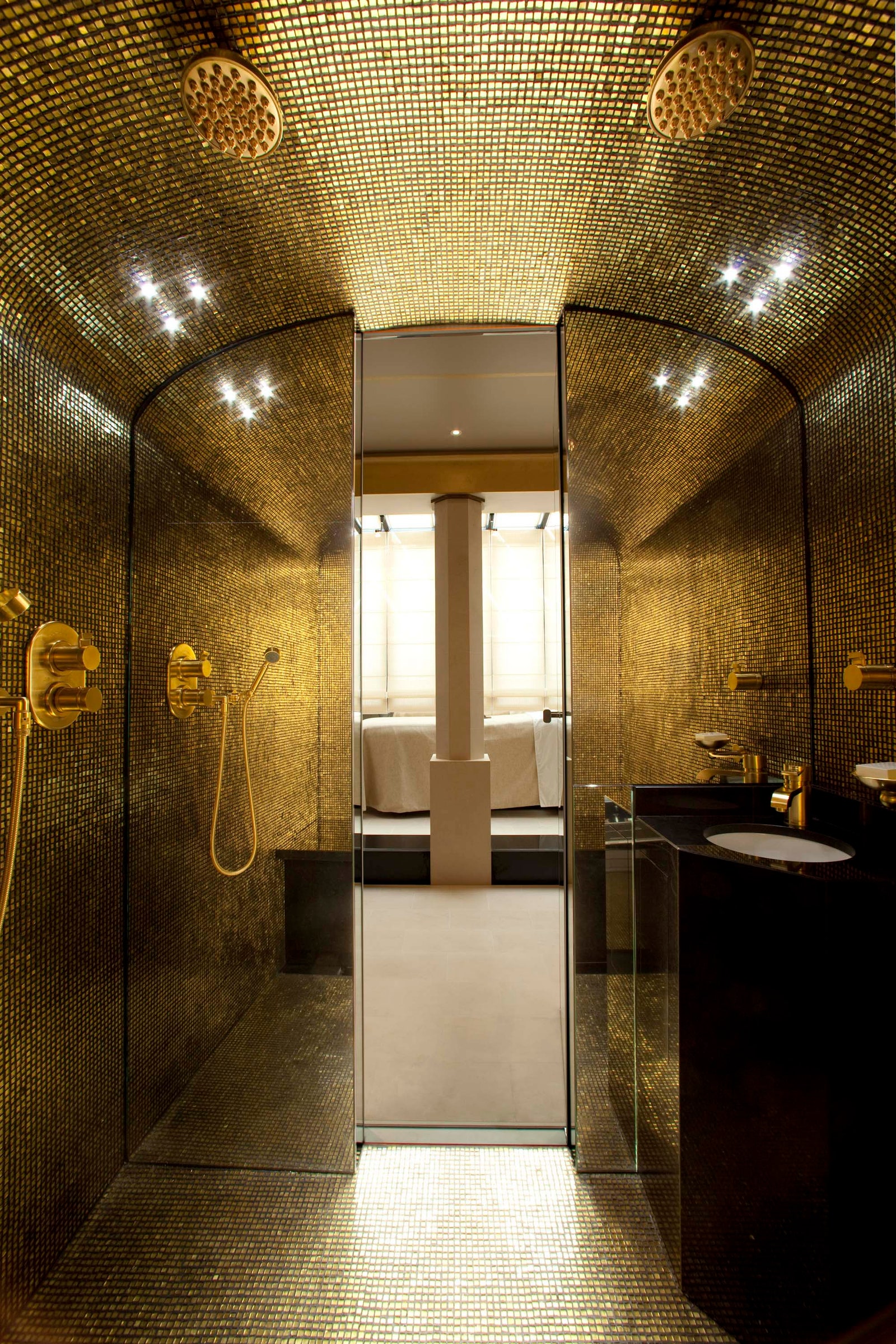 Images may contain indoor sink bathroom bathroom shower faucet faucet faucet interior design bed furniture floor and cup