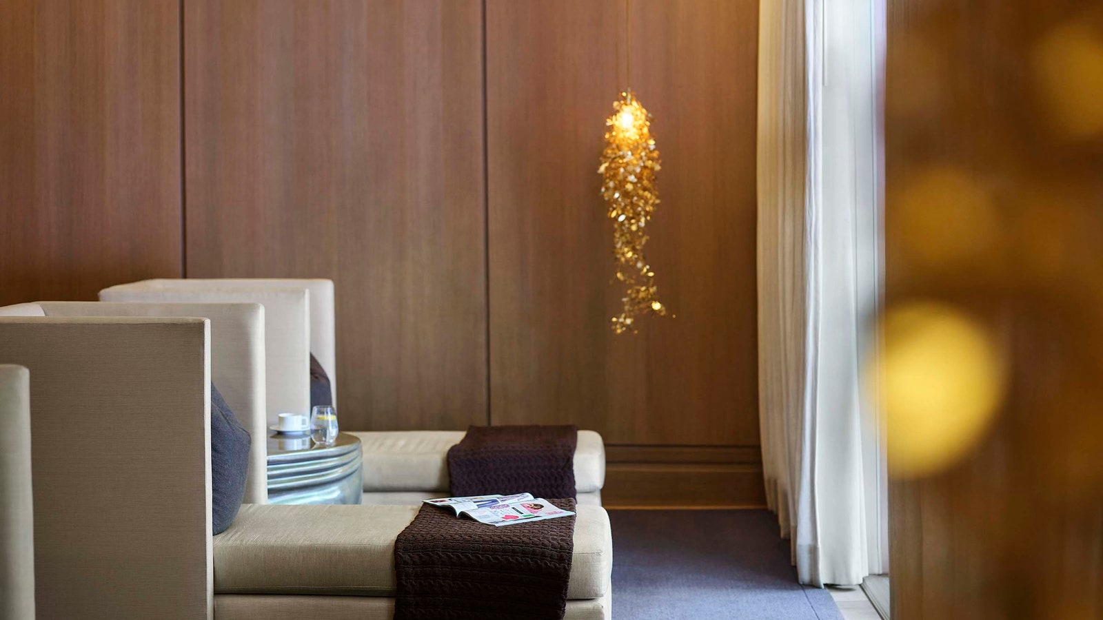 Images may contain interior interior design book publications wood panel sofa furniture chandeliers and lights
