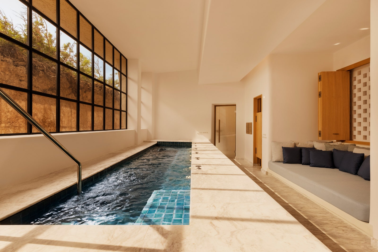Images may contain interior design floor pool water pool sofa and floor