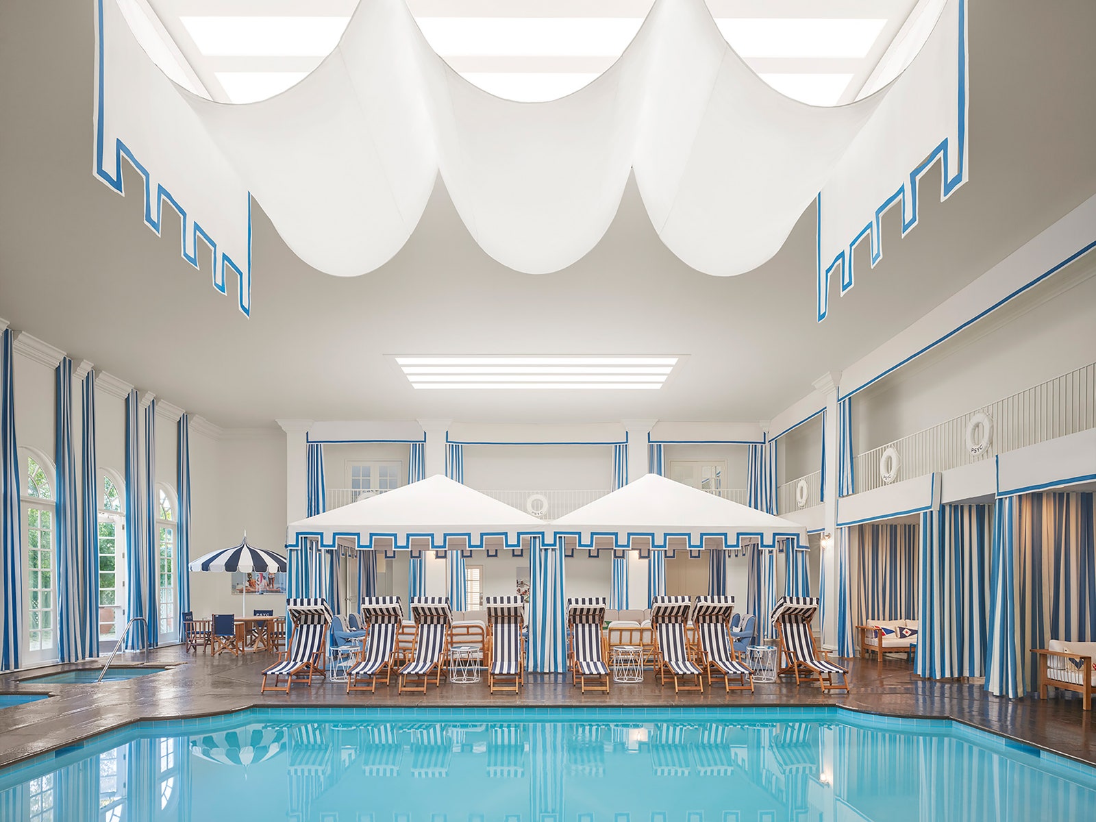 Images may contain swimming pool water swimming pool building hotel hotel chairs and furniture