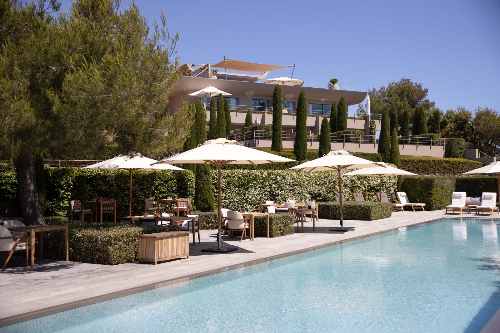 Images may contain architecture houses houses villa chairs furniture hotel hotel pool water and table