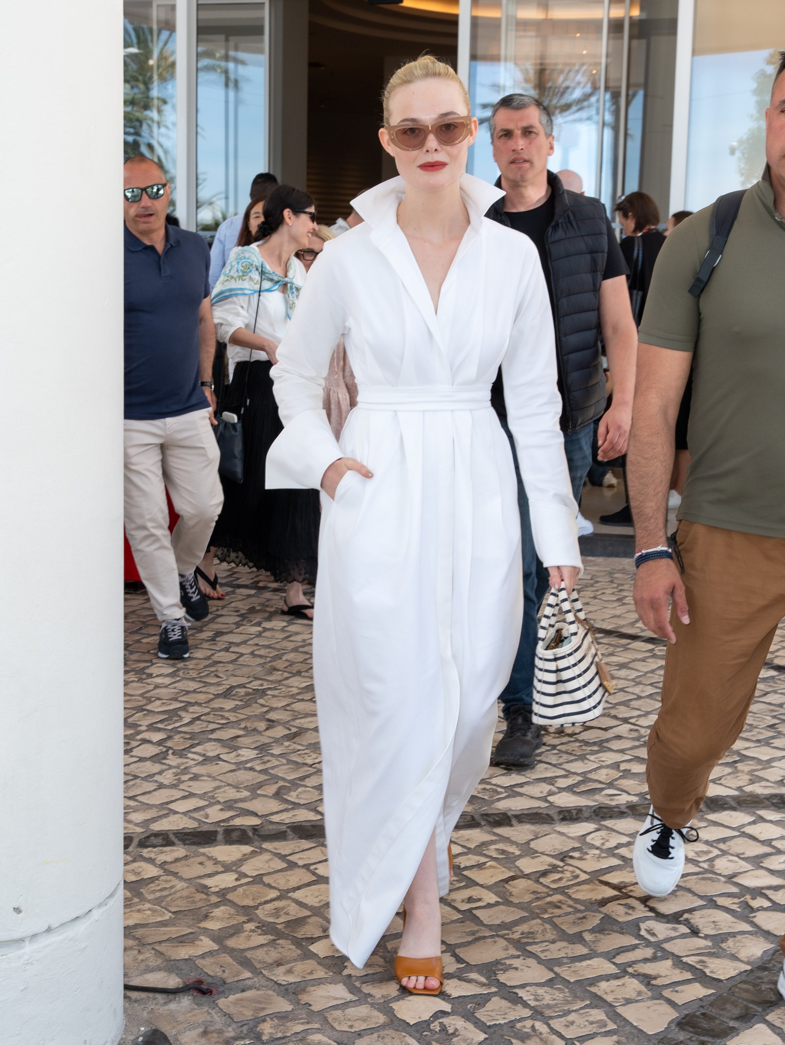 Images may contain Elle Fanning Layla Moran Person Accessories Bag Handbag Glass Clothes Shoes Shoes and Adults