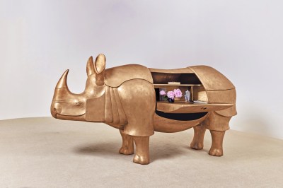 Grand Rhinocéros II by François-Xavier Lalanne (2003), a life-size sculpture of golden bronze, brass and leather tables with animal shapes. Image by Sotheby's.