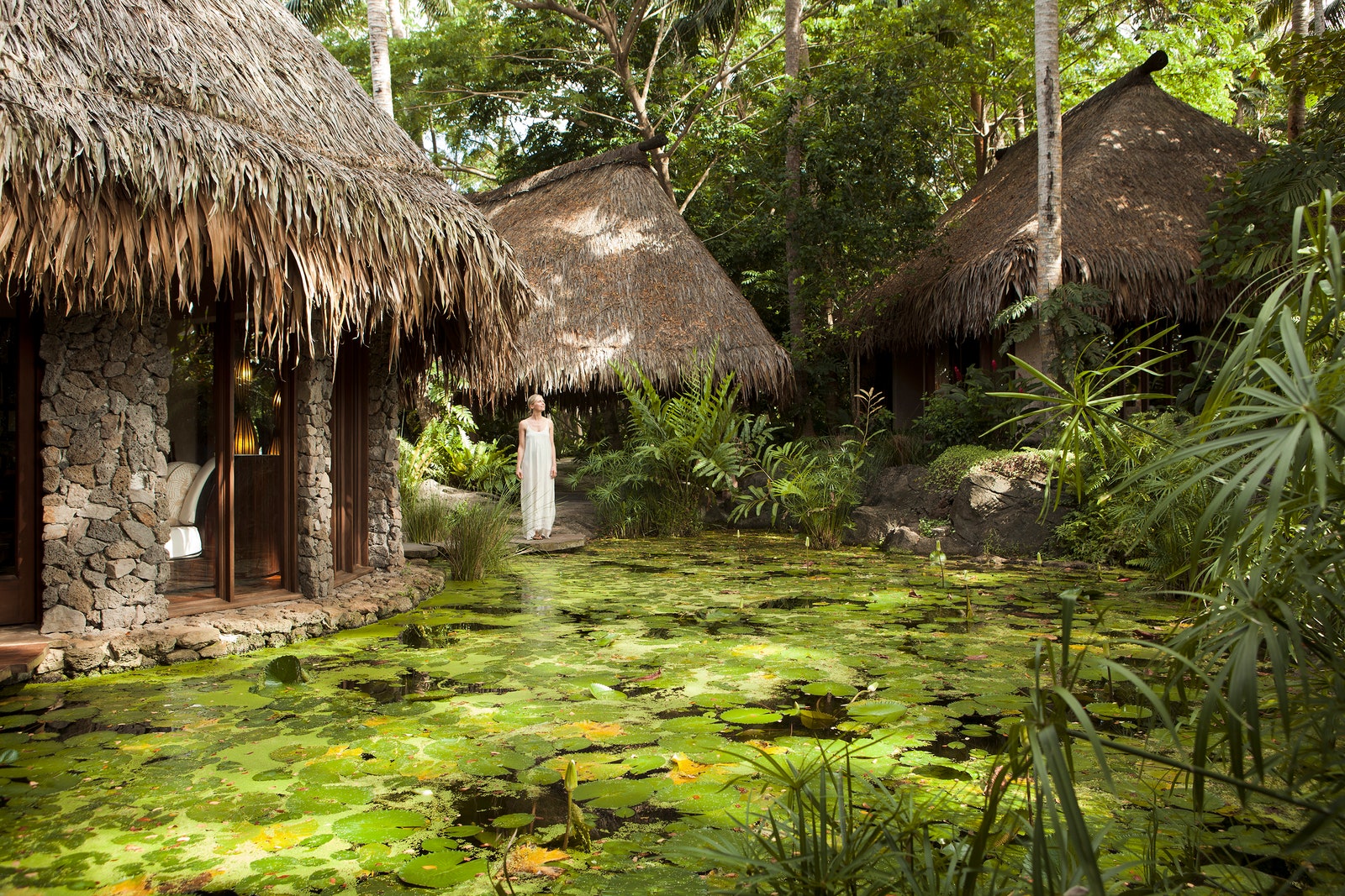 Image may contain people in buildings, hotel resorts, nature outdoor country cottage, rural pond and water