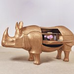 Grand Rhinocéros II by François-Xavier Lalanne (2003), a life-size sculpture of golden bronze, brass and leather tables with animal shapes. Image by Sotheby's.