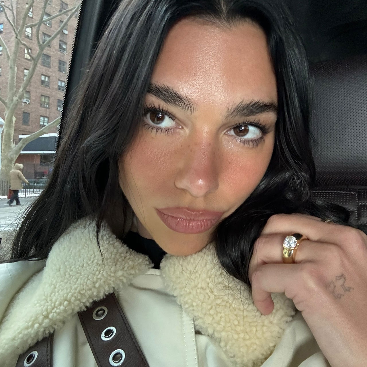 Images may contain dua lipa adult accessories bag handbag head and face jewelry rings and skin