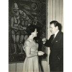 A man and a woman in front of the painting.
