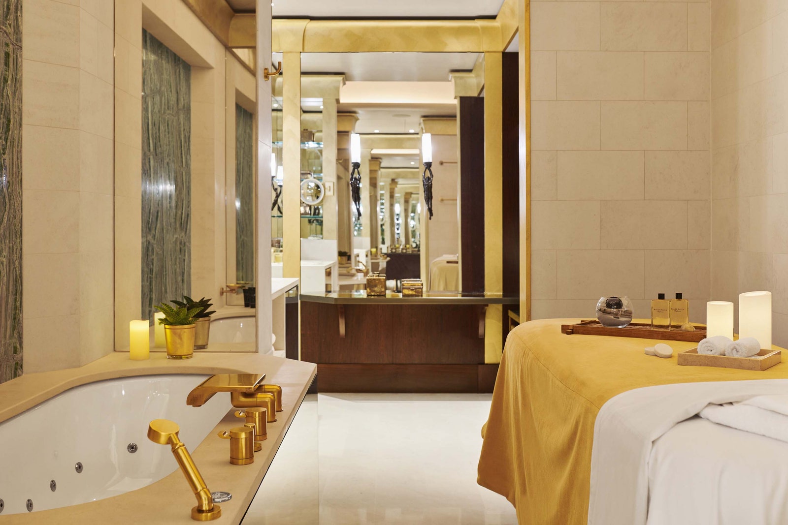 Image may contain plant bed furniture bathroom candle sink faucet interior design bathtub and bathtub