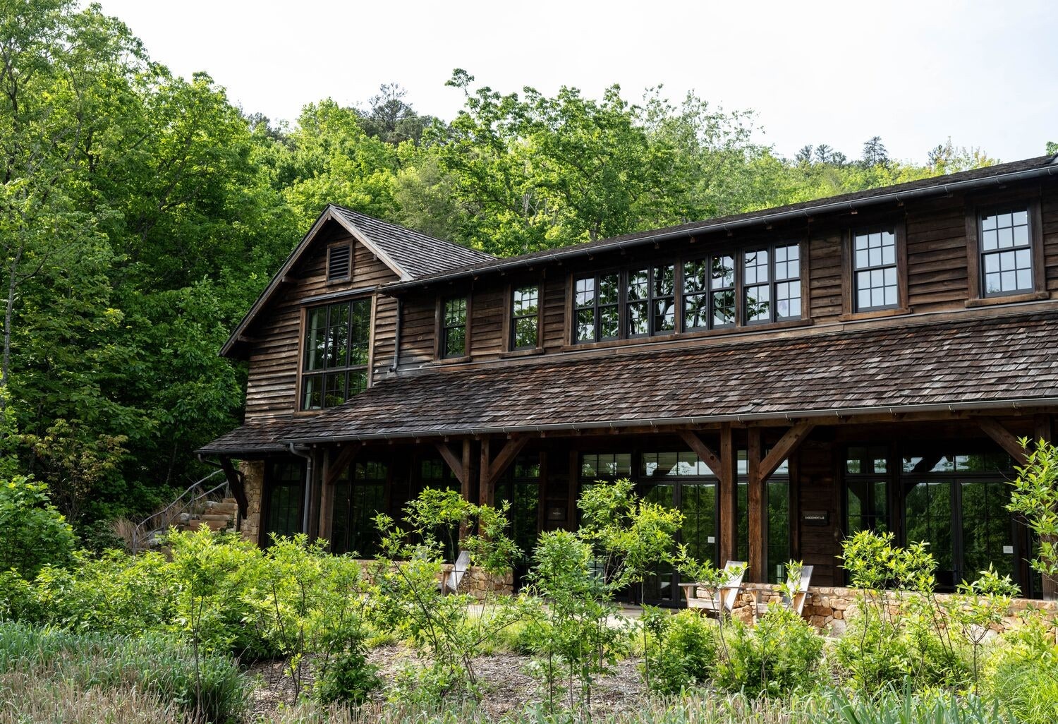 Images may contain architecture building cabin house house housing cabin natural outdoor scenery chairs and furniture