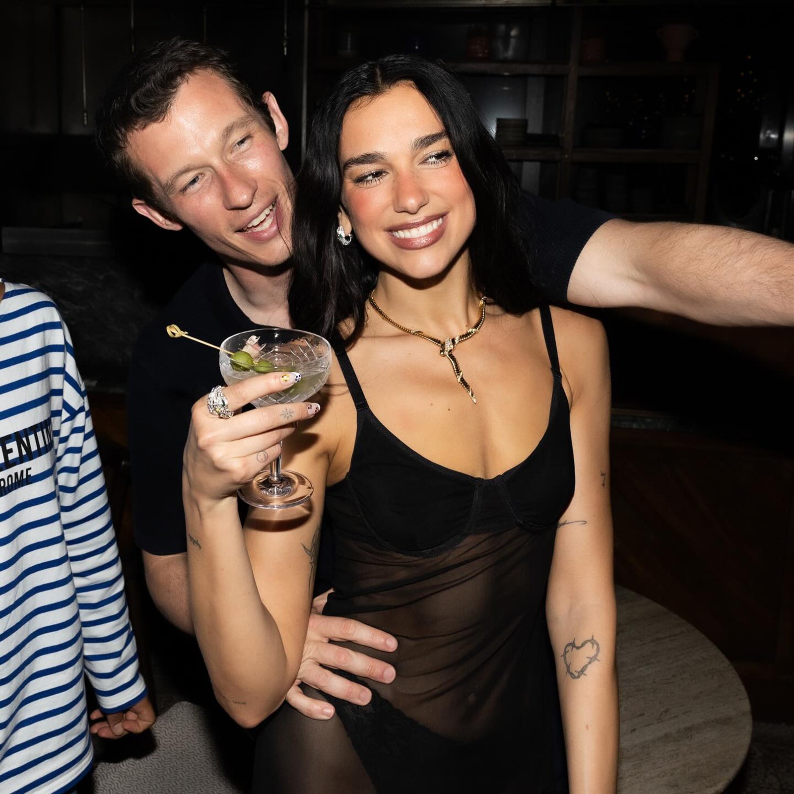 Image may contain Callum Turner Dua Lipa accessories Jewelry ring necklace Photography city adult and fun