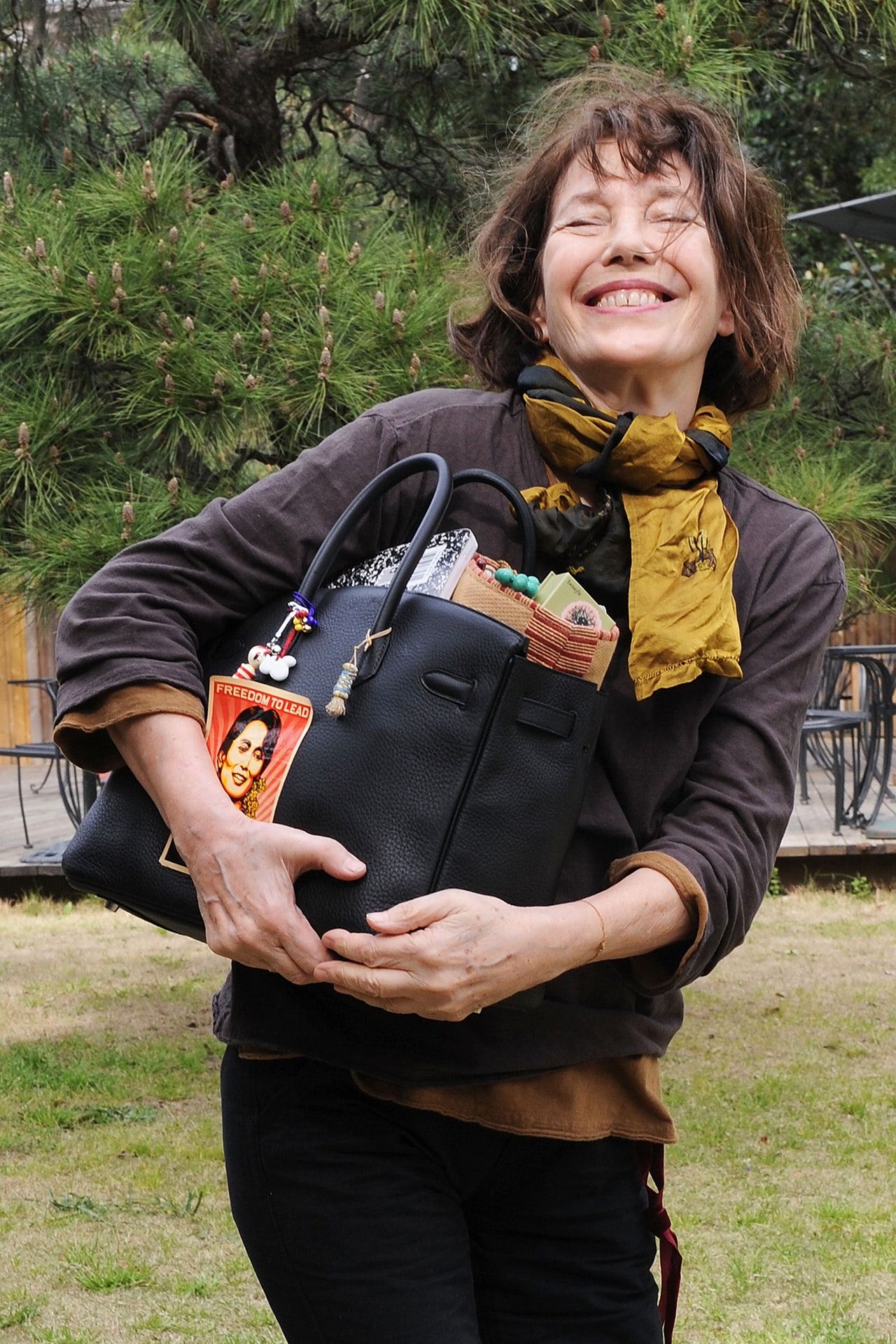 Images may contain Jane Birkin Aung San Suu Kyi Face Head Photography Portrait Accessories Bag and Handbag