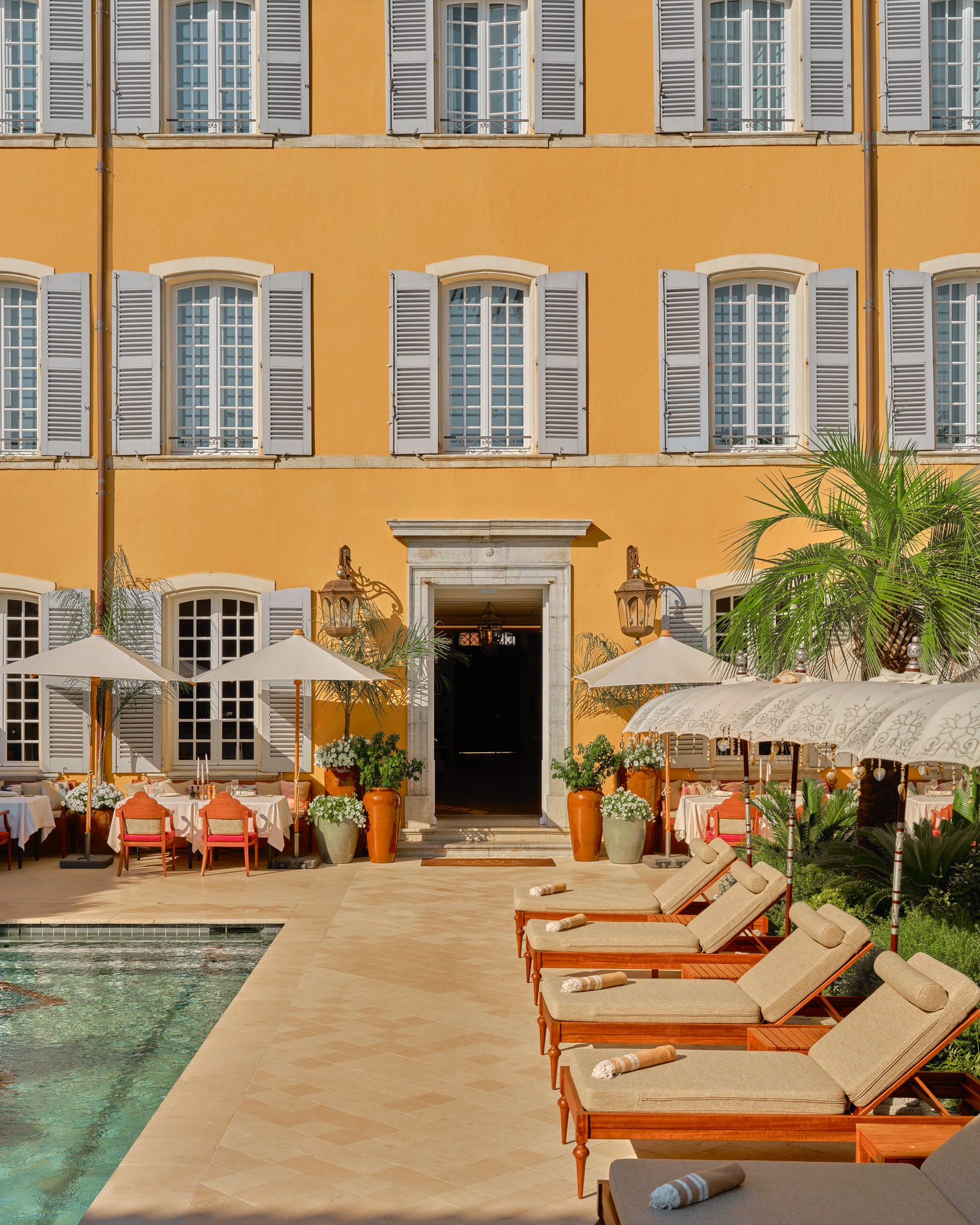 Images may contain architecture, hotel style chairs, furniture, plants, city apartments, housing and villas