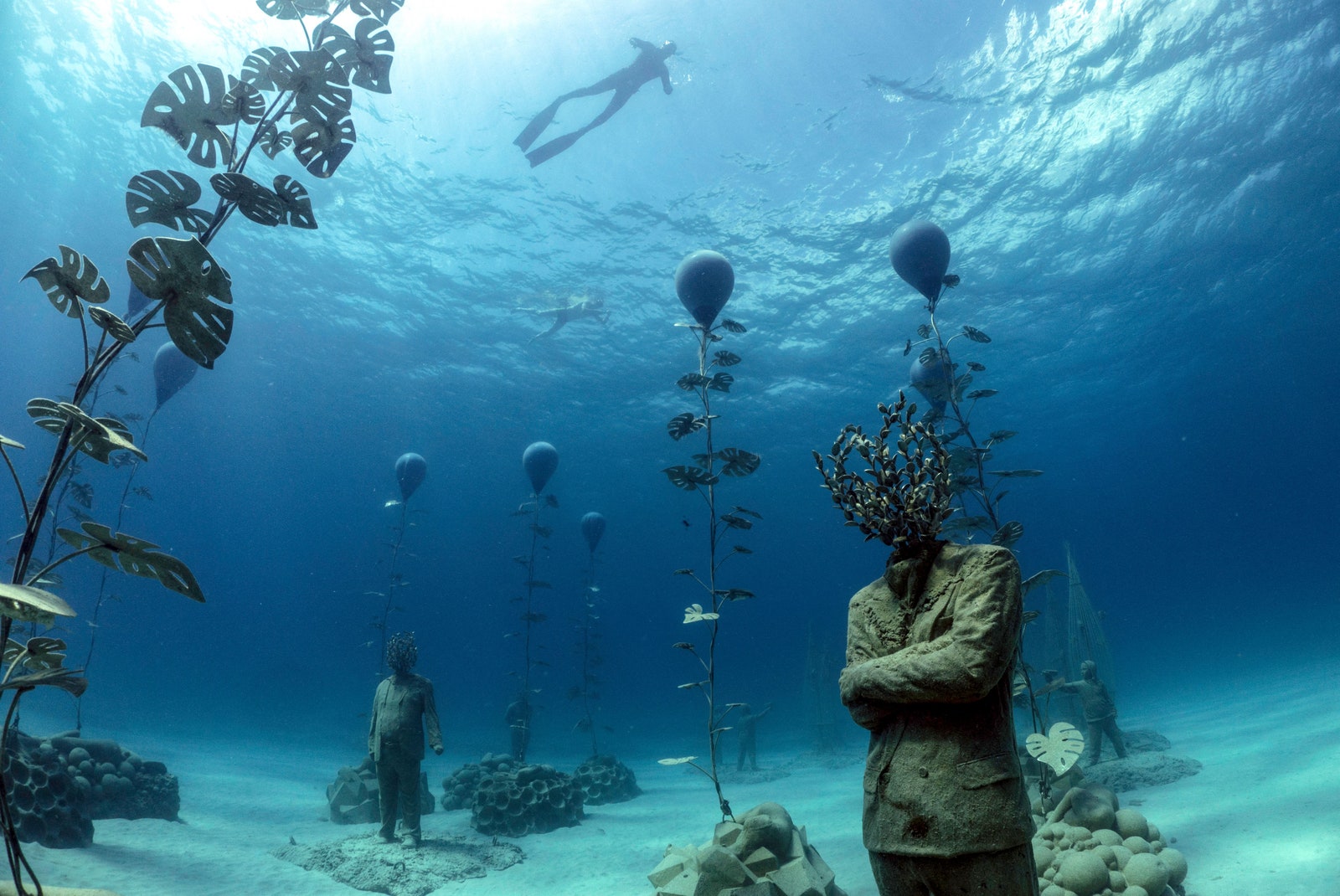 Images may contain underwater aquatic balloon accessories and bags naturally outdoors underwater people under the sea