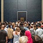 A group of people in front of the painting.