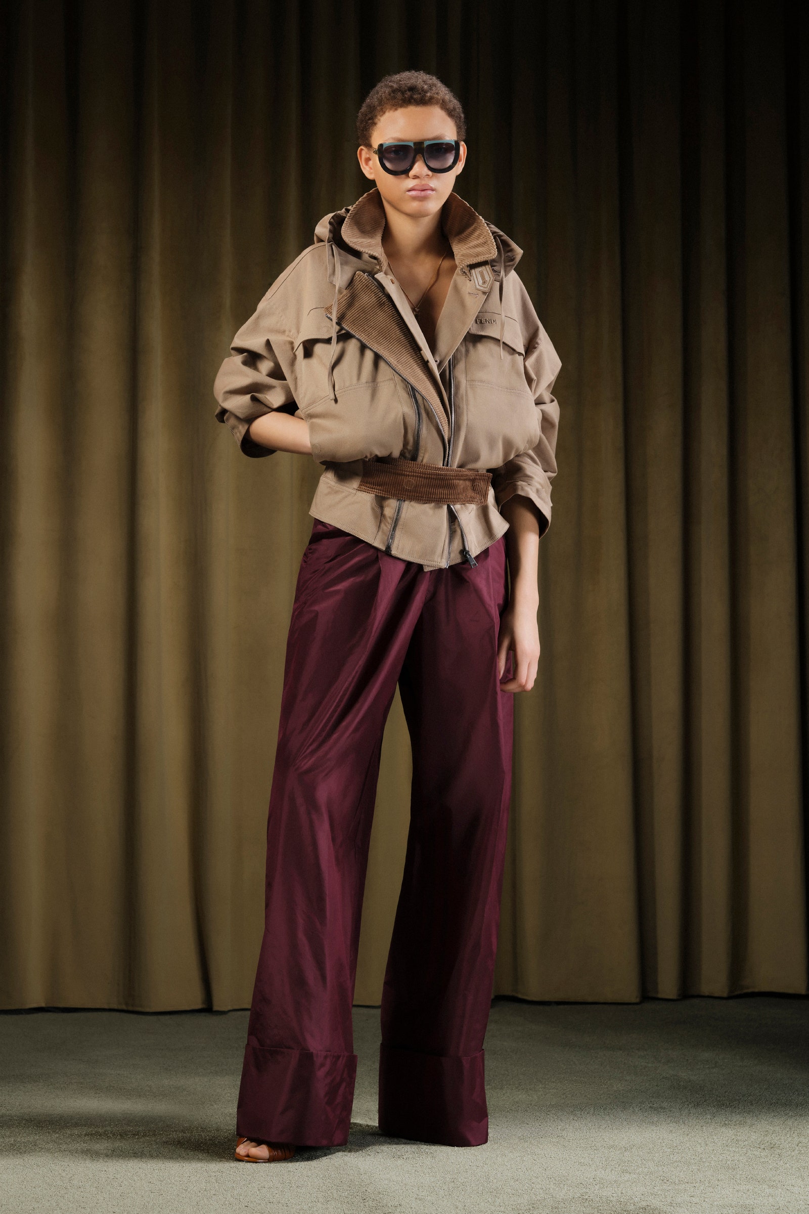 Images may contain clothing pants fashionable adult jacket accessories jewelry necklace tops and glasses