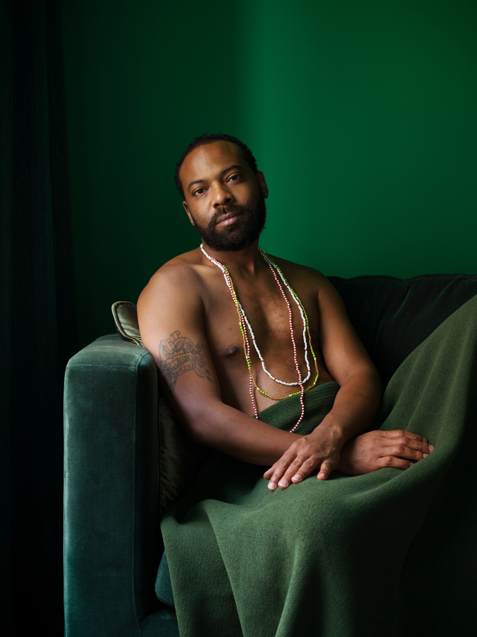 Images may contain Hassan Johnson's man sitting adult face photography portrait accessories and jewelry