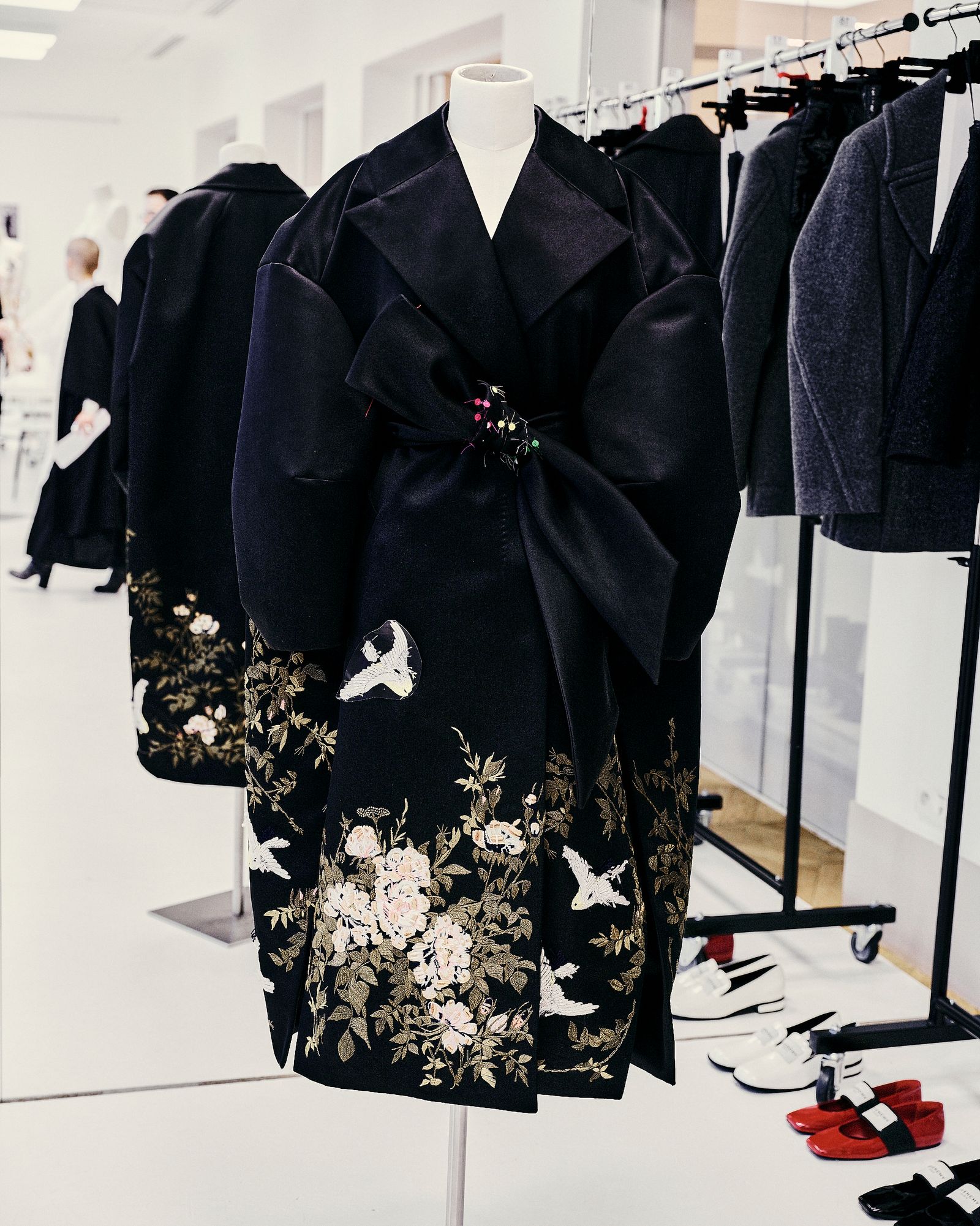 Images may contain clothing dress formally wearing fashionable dress coat robe high heels adults and people