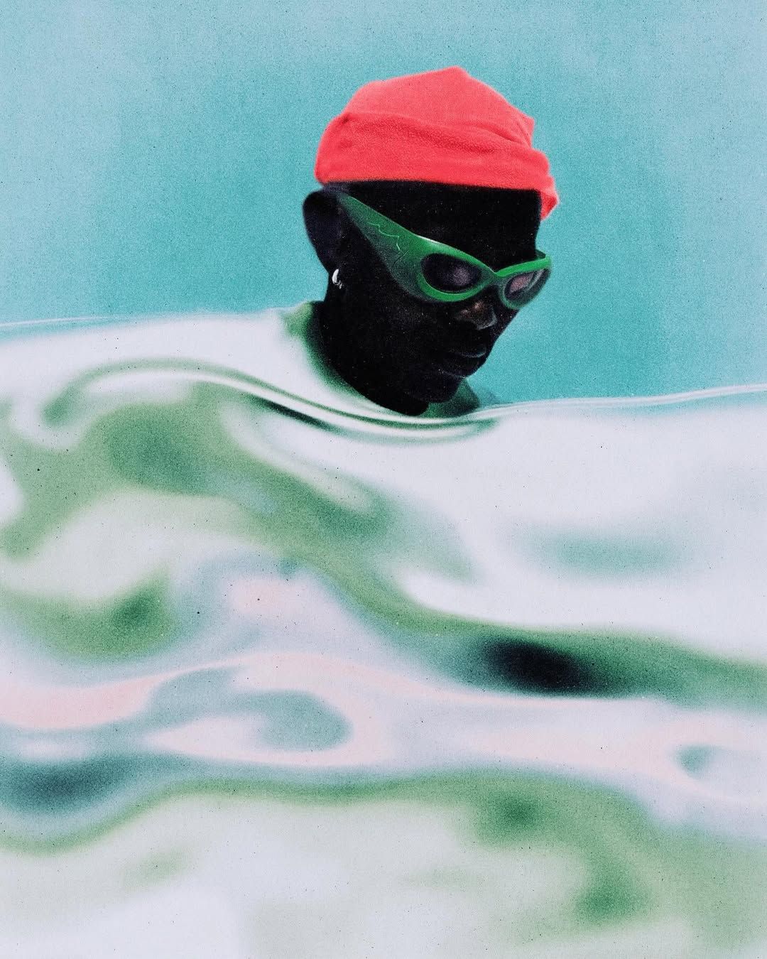 Images may contain hats, shower caps, leisure activities, sports, swimming and water