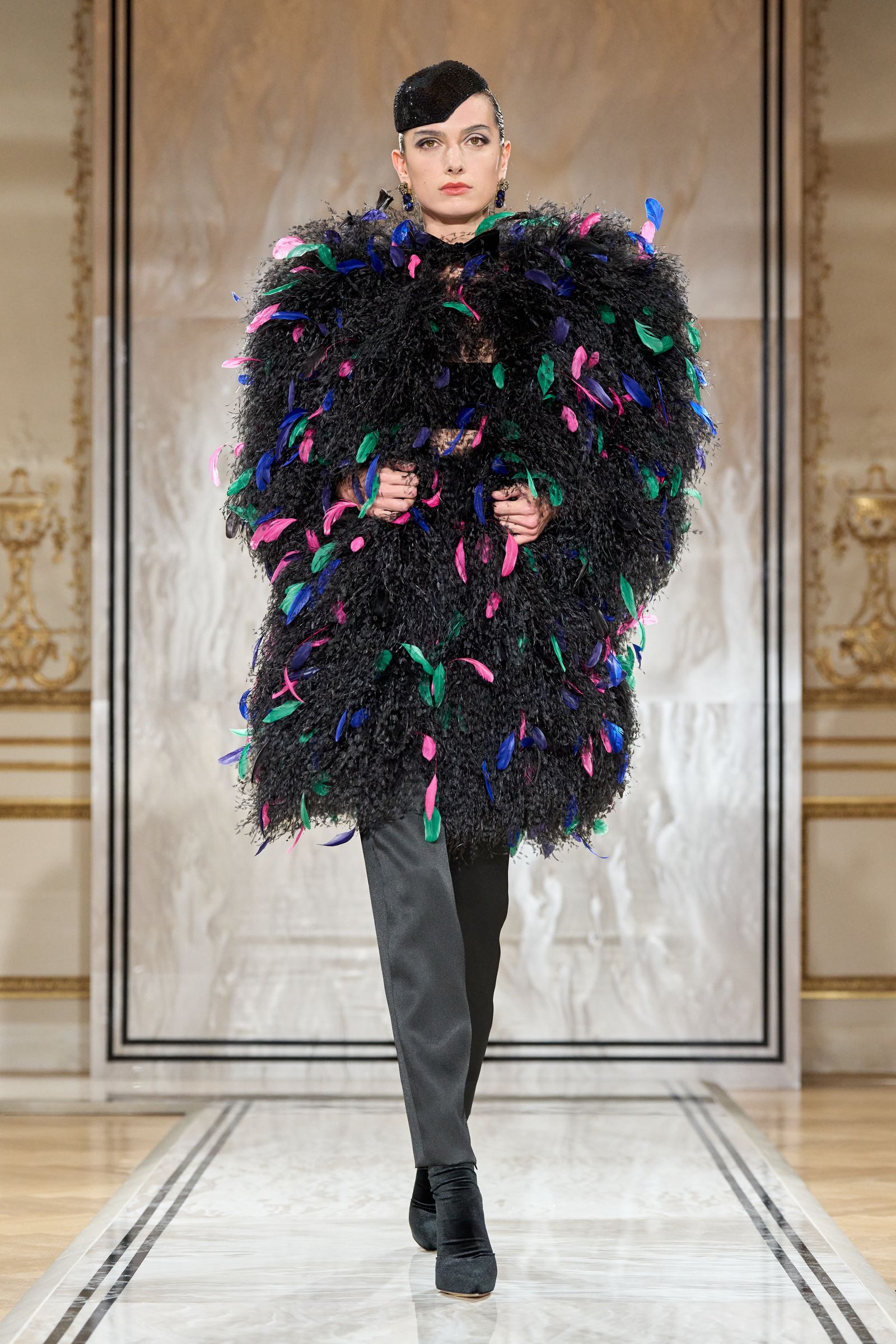 Images may contain cape outfit adult fashion jacket and runway
