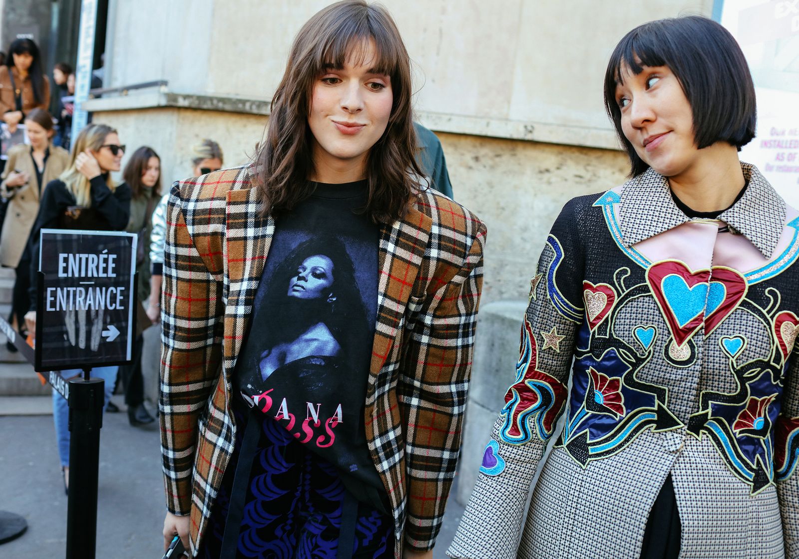 Hari Nef in Sacai pants and Eva Chen in Mary Katrantzou coat