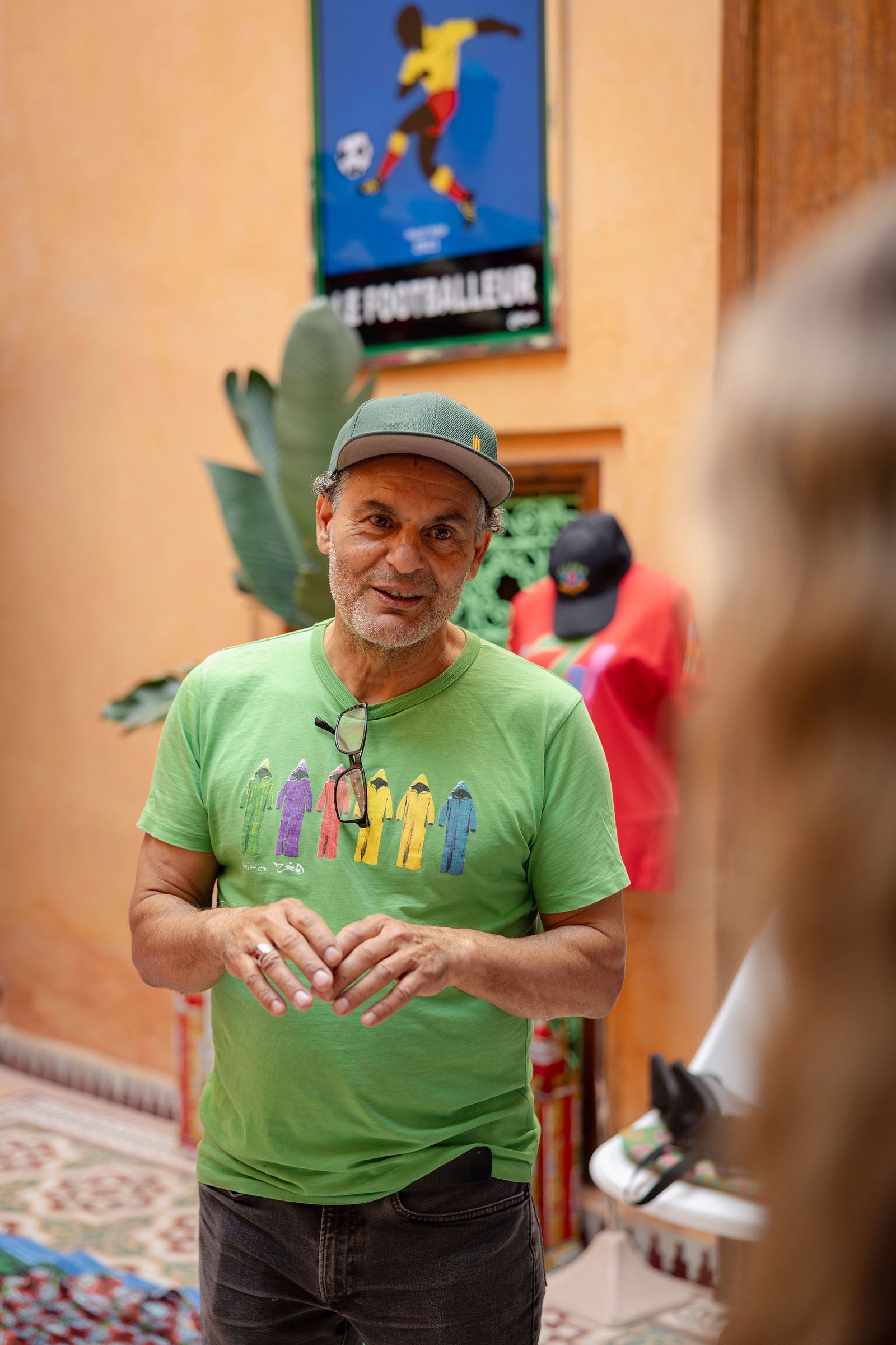 Images may contain Fred Ewanuick Clothing T-shirt Hat Body Parts Finger Hands Character Adult Faces and Photography