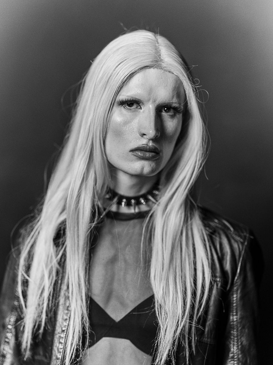 Images may contain blonde face photography portrait adult clothing and jacket