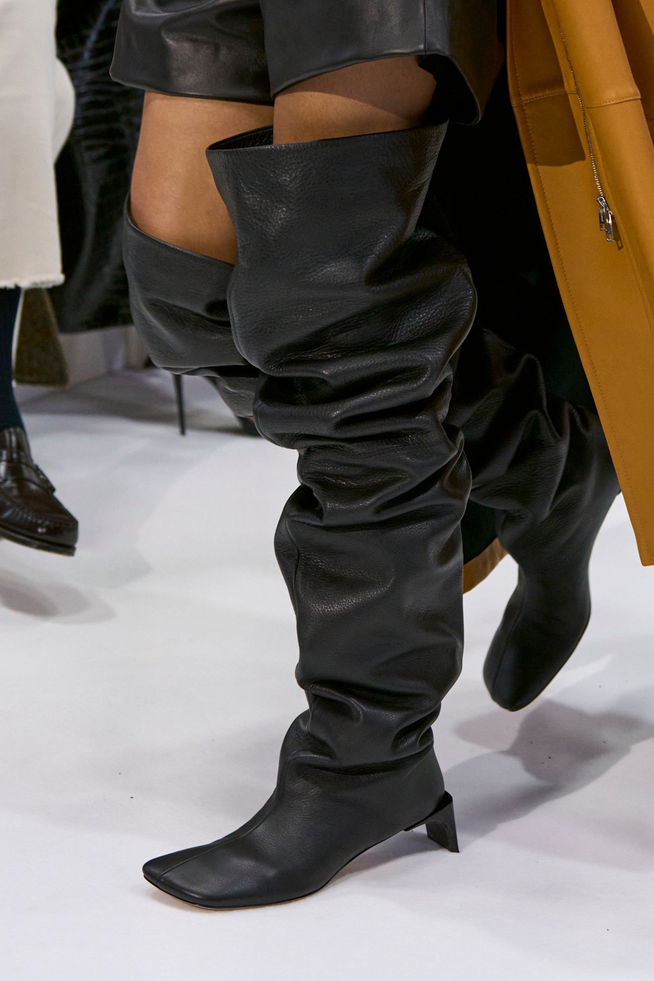Images may contain clothing shoes, high heels, adults and boots
