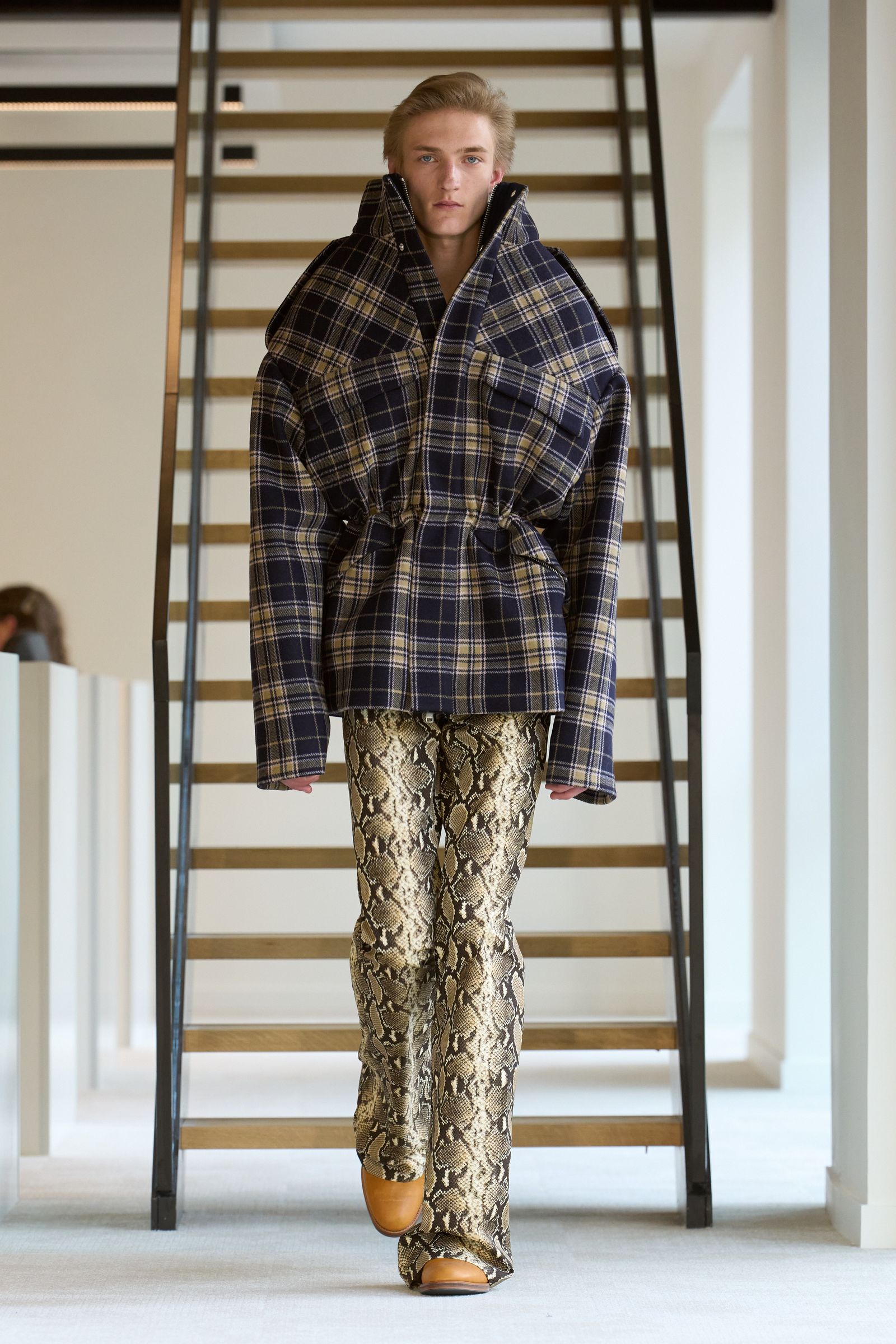 Image may contain Aliocha Schneider Fashion Clothing Pajamas Man Standing Pants and Shoes