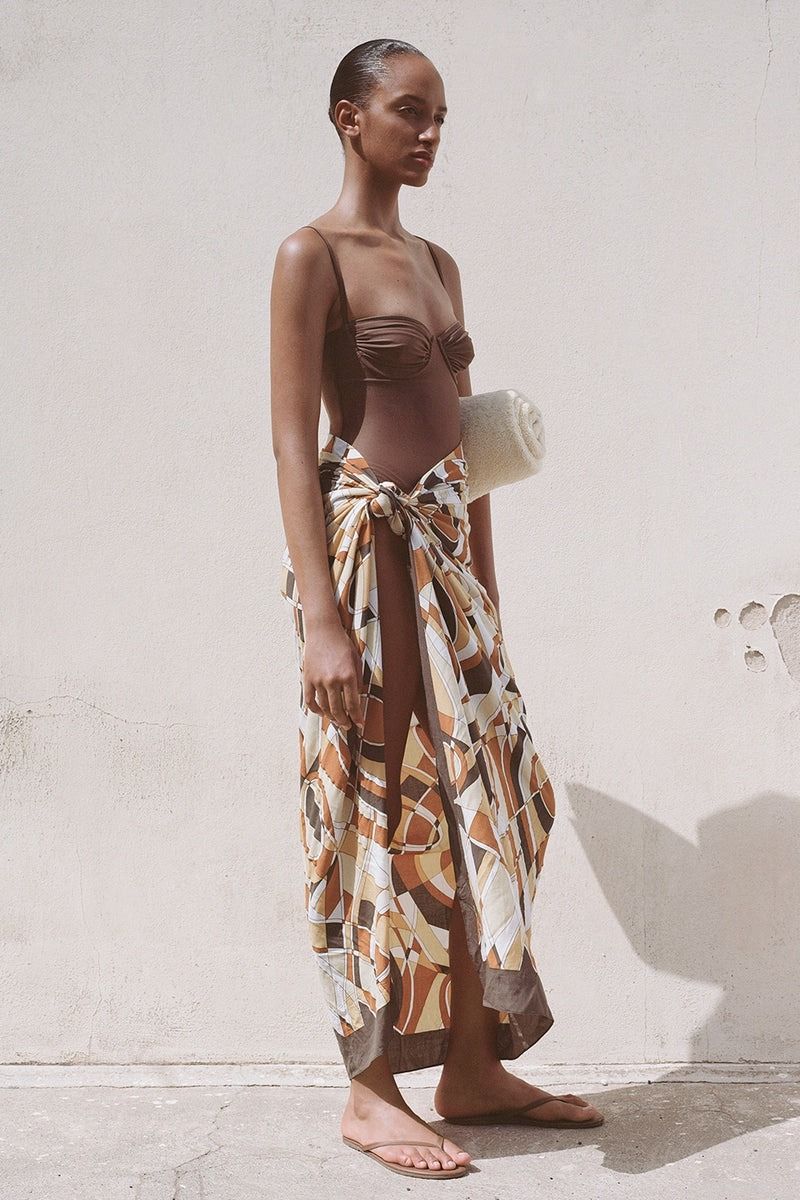Images may contain beachwear clothing adult footwear sandals dresses and formal wear