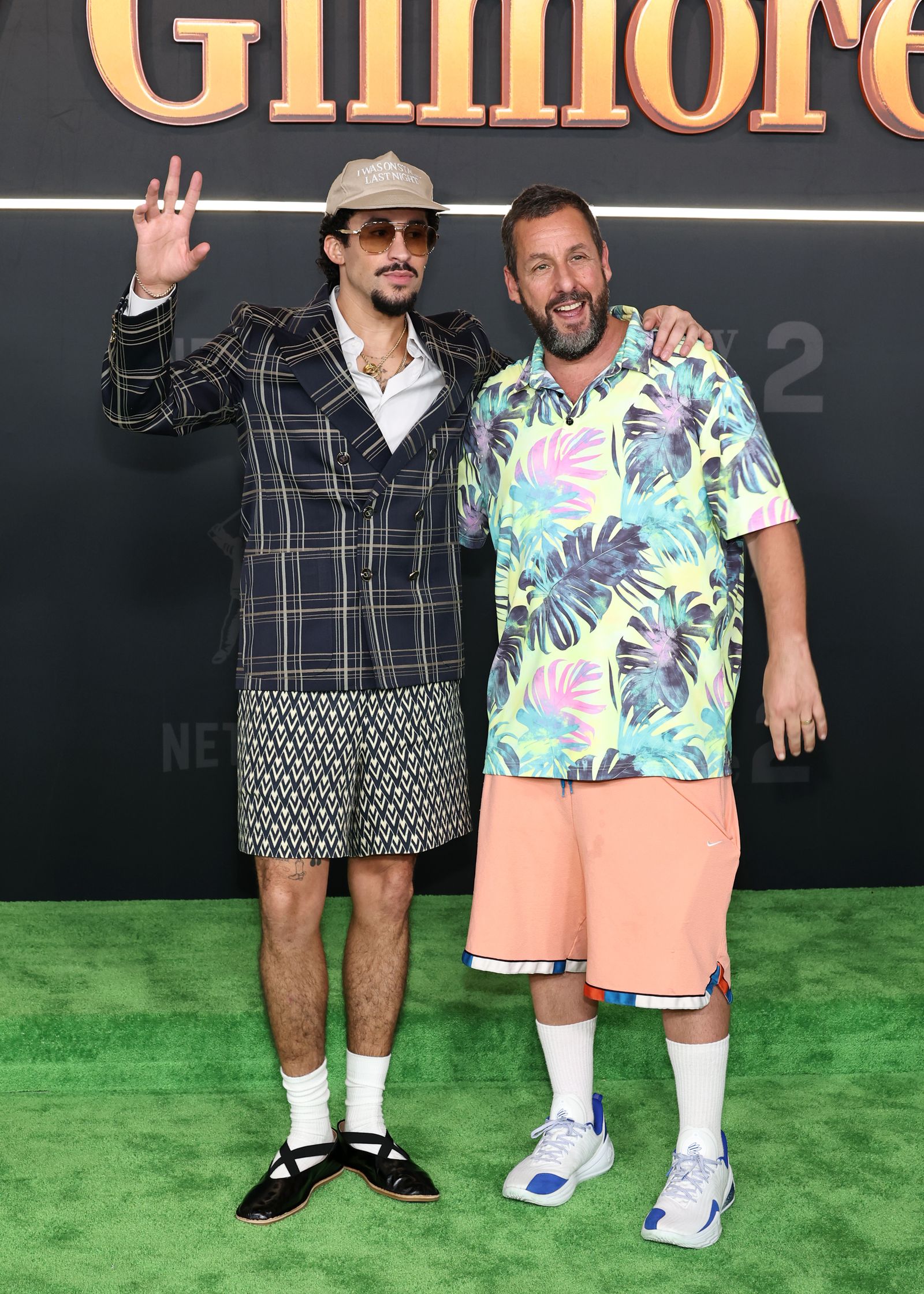 Images may contain Adam Sandler bad bunny clothes shorts adult shoes shoes photo rackets and sports