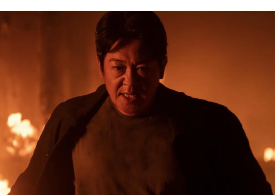 A man stood in the middle of a fire.