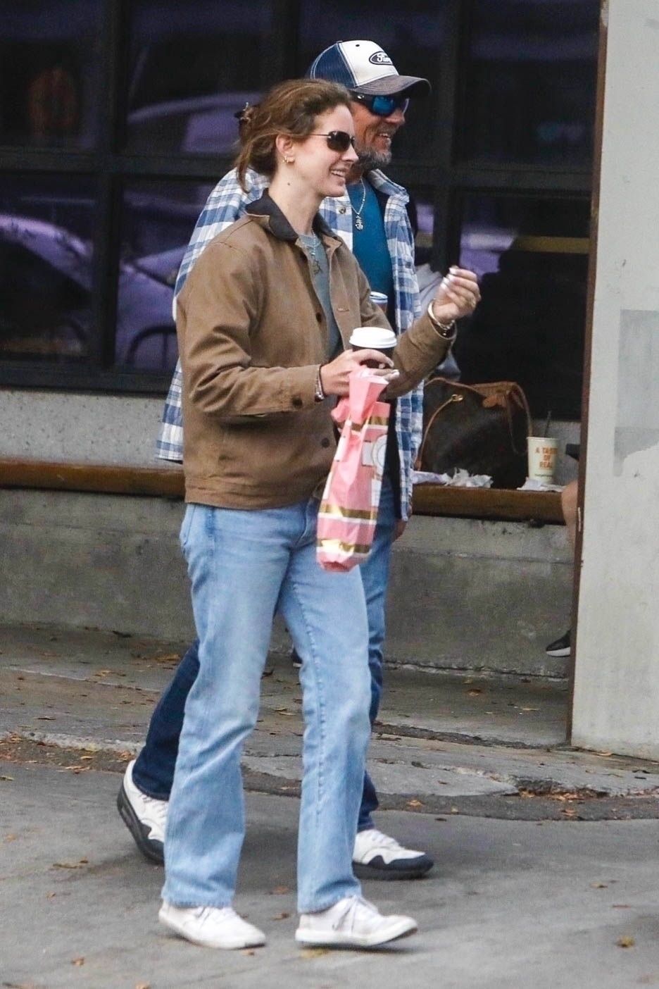 Images may contain Lana del Rey clothing pants baseball cap hat jeans accessories handbags and shoes