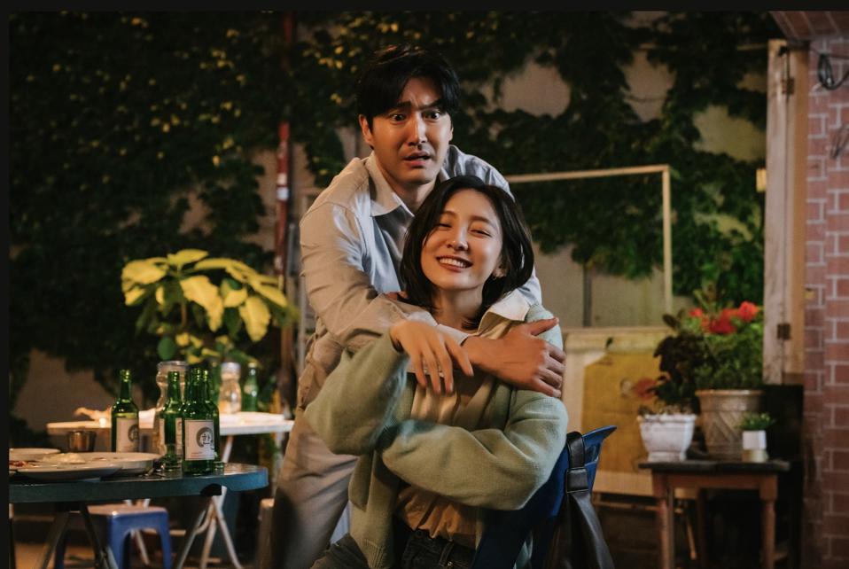 A man looks cares when the woman tries to hug him.