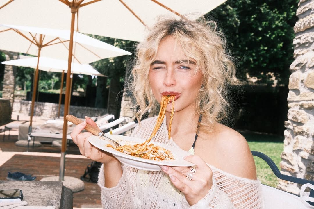 Images may contain Sabrina Carpenter adults eating food accessories jewelry ring electronics and cell phones