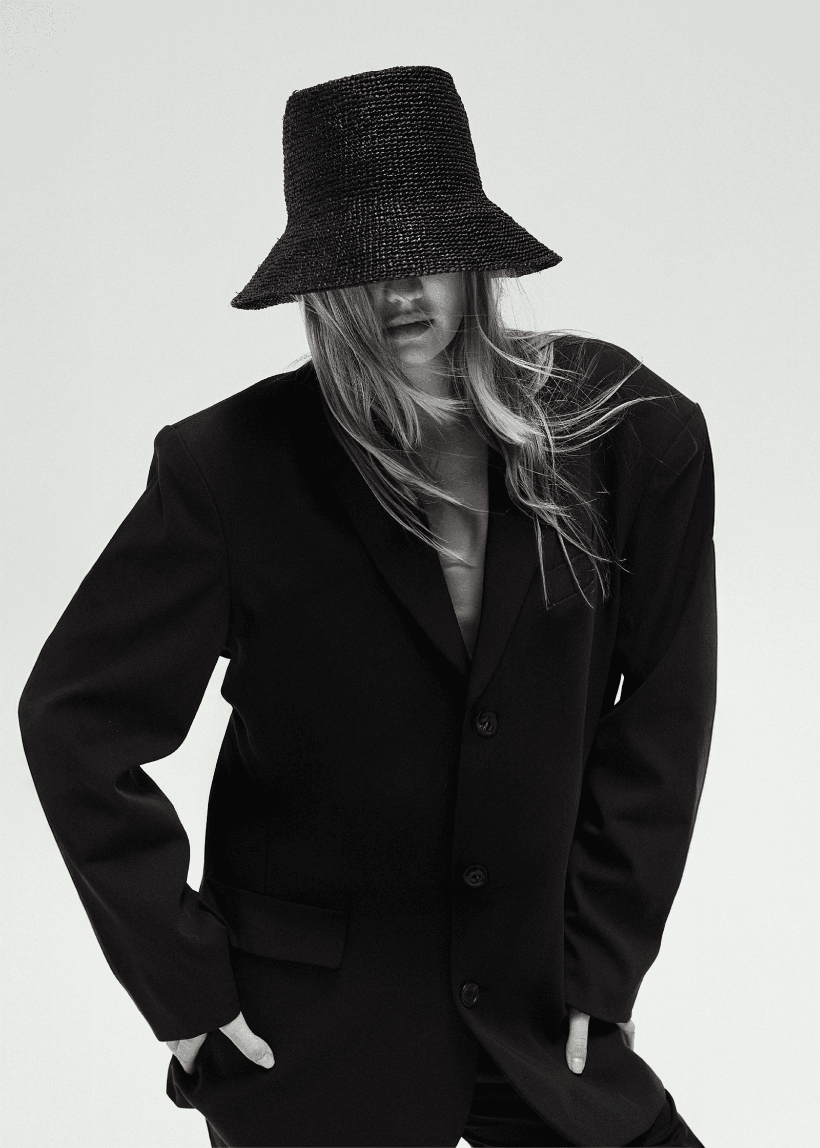 Images may contain clothing, hat, jacket, formal wear, blazer, adult jacket, face and head