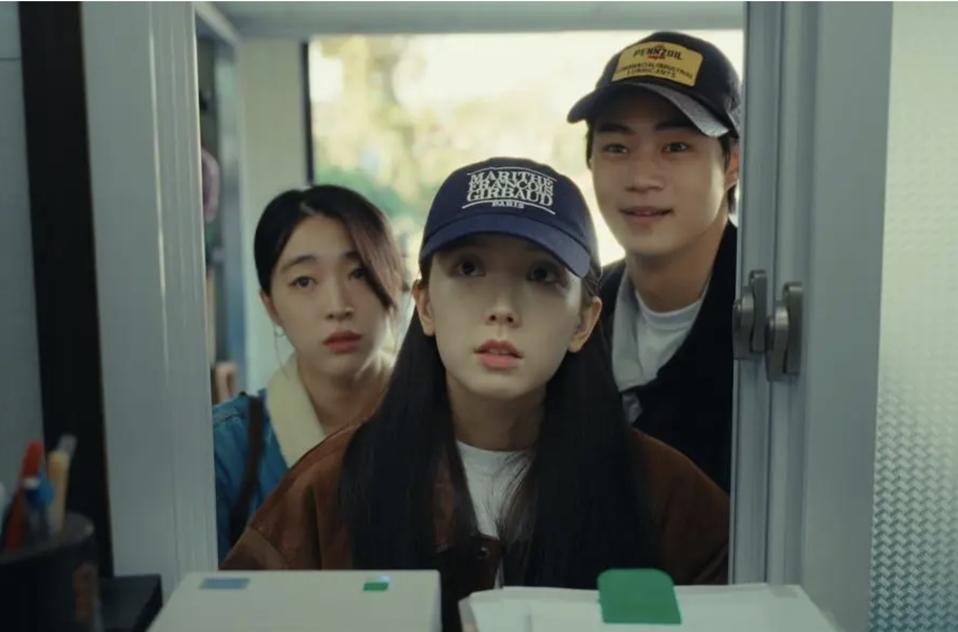 Two young women and a man looking at the lost window.