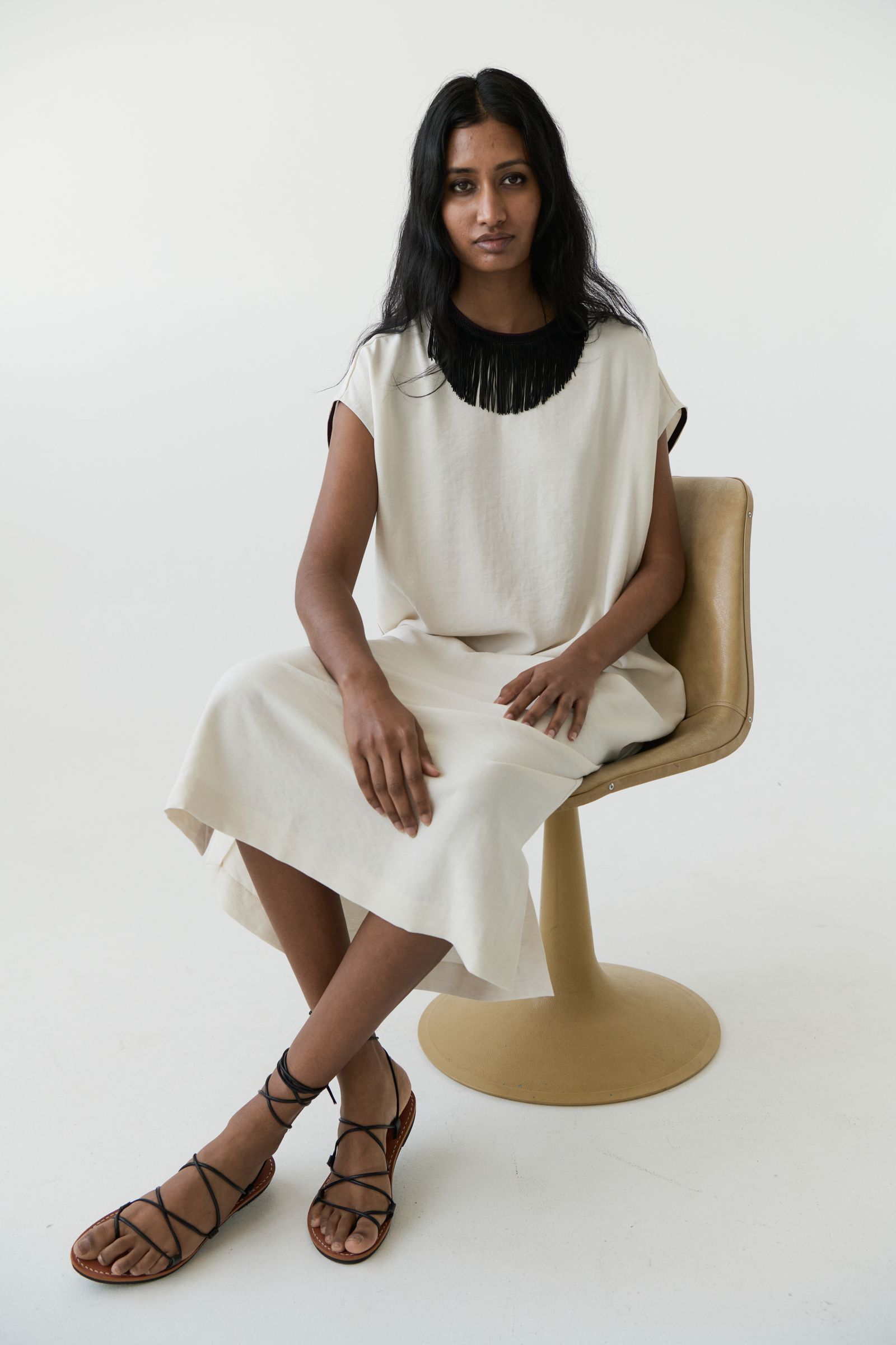 Images may contain clothing shoes sandals shoes sitting adult high heels and clothes