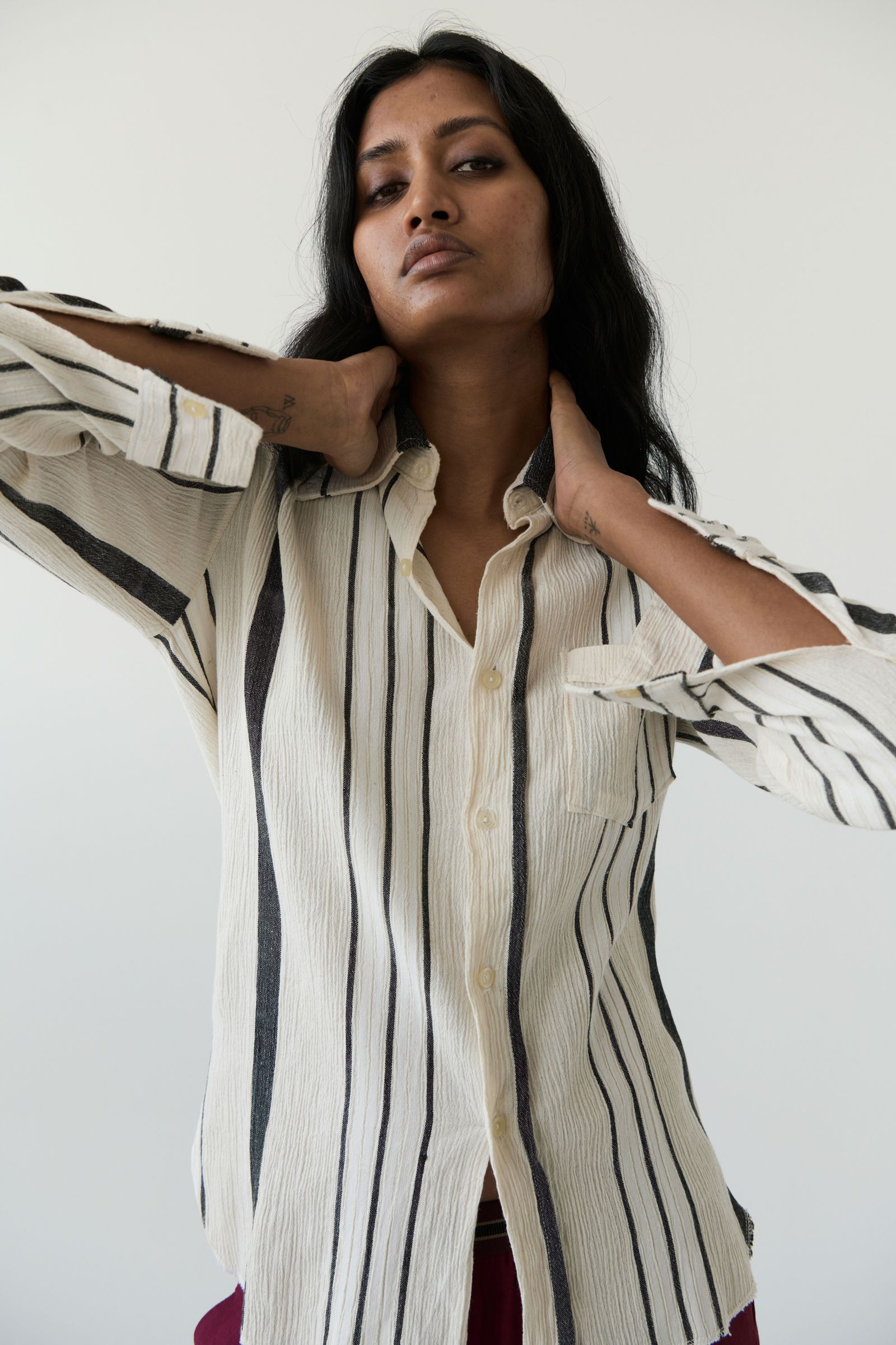 Images may contain clothing shirt top long sleeve sleeve adult face photography portrait and coat
