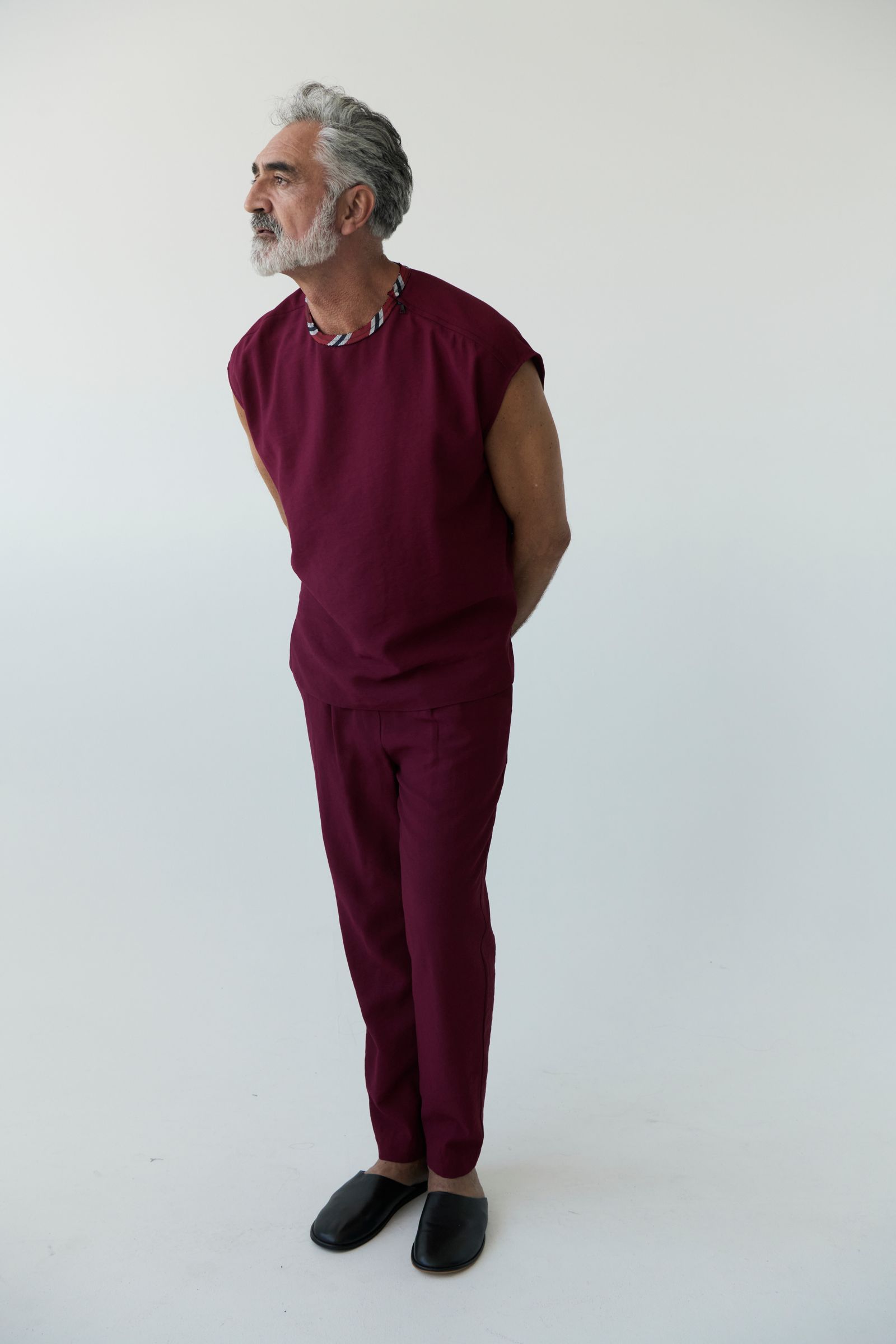 Images may contain adult face photography portrait standing outfit formally wearing suit and trousers