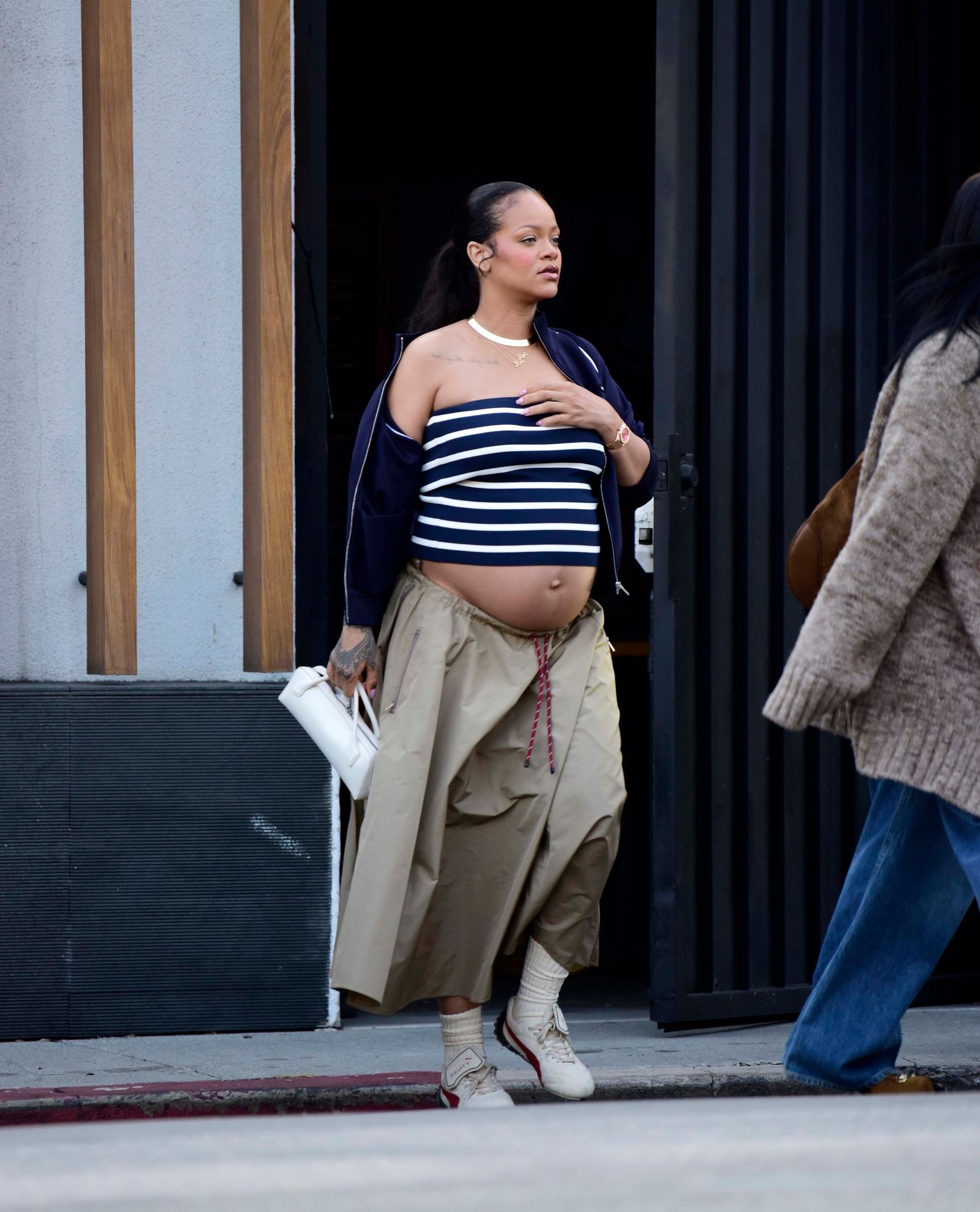 Images may contain Rihanna pedestrian clothing shoes shoes adult accessories handbags and jewelry