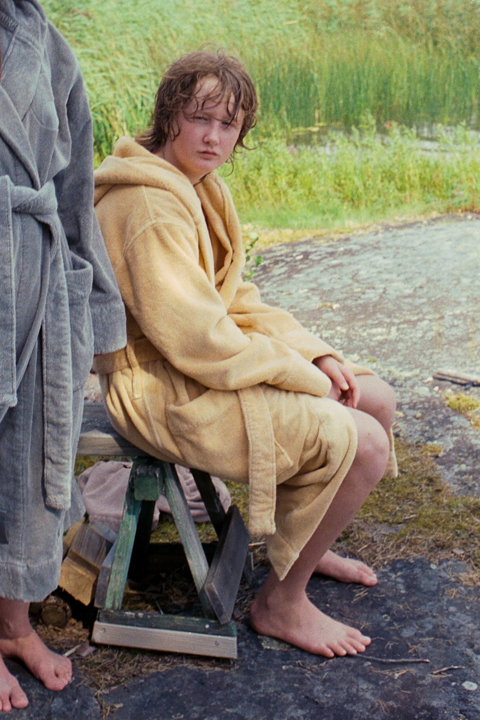 Image may contain face photography portrait of barefoot man sitting in fashionable blanket clothes and pants