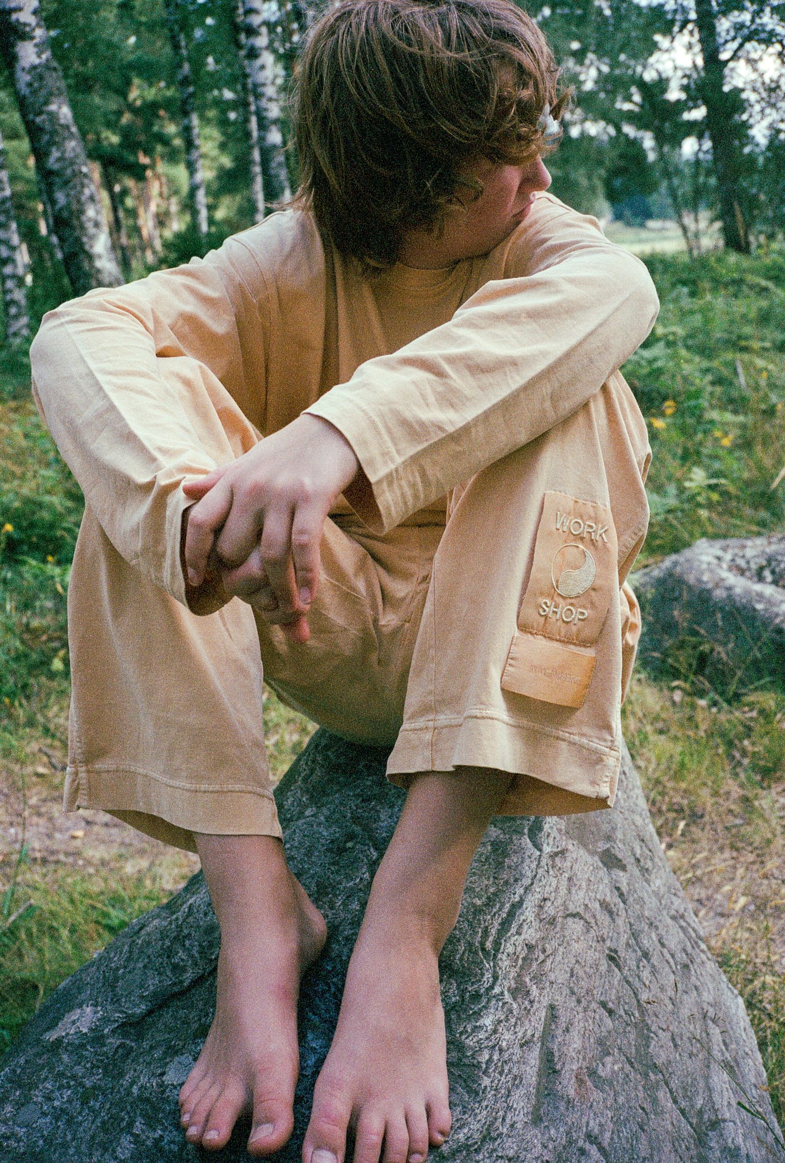 Images may contain rock face people photography portrait plants vegetation barefoot trees clothes and pants